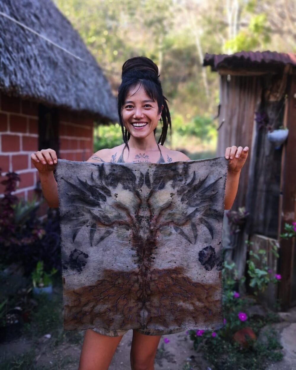 the maker holding a finished botanical print in mazunte